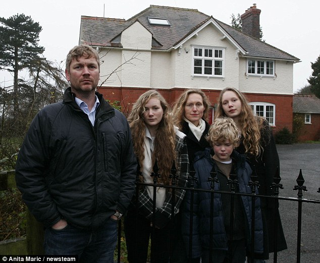 'Forced out': Reverend Mark Sharpe with wife Sara and children Naomi, Lydia, and Thomas at the Worcestershire rectory where life was so miserable for them